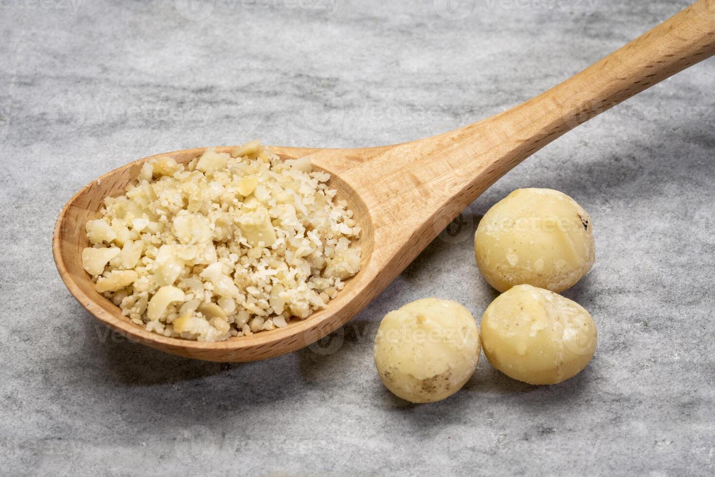 macadamia nut flour on a wooden spoon photo