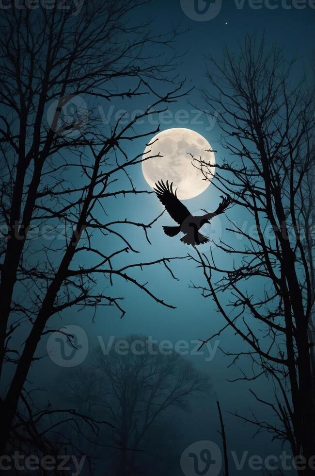 A silhouette of a bird flying against a full moon, framed by bare trees in a misty atmosphere. photo