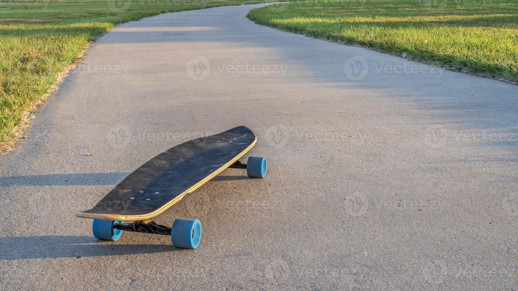 cruising longboard on a bike trail photo
