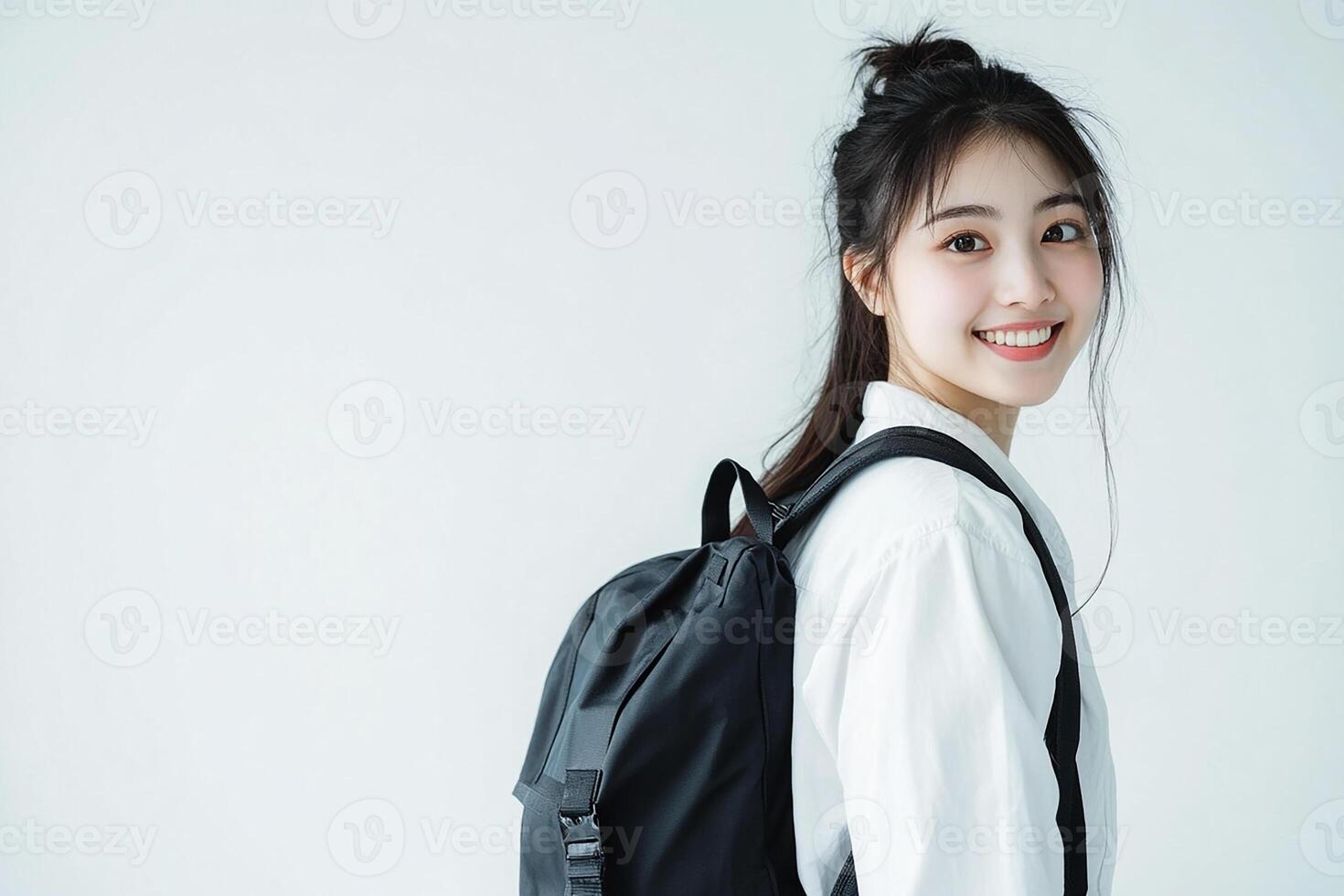 Asian woman with backpack smiling photo