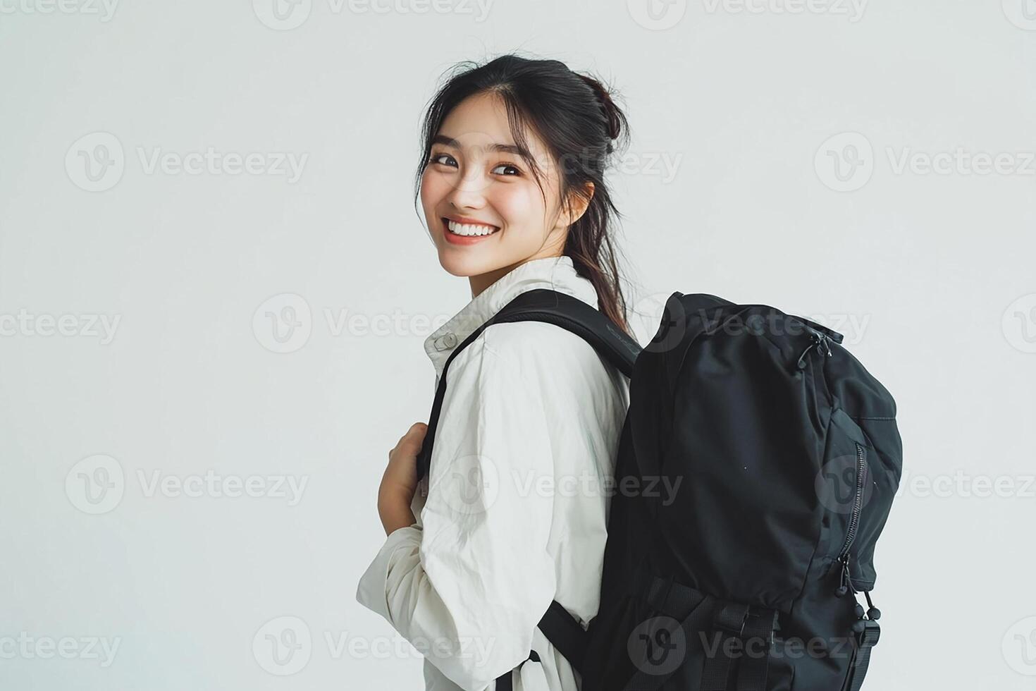 Portrait of asian woman with backpack on white background photo
