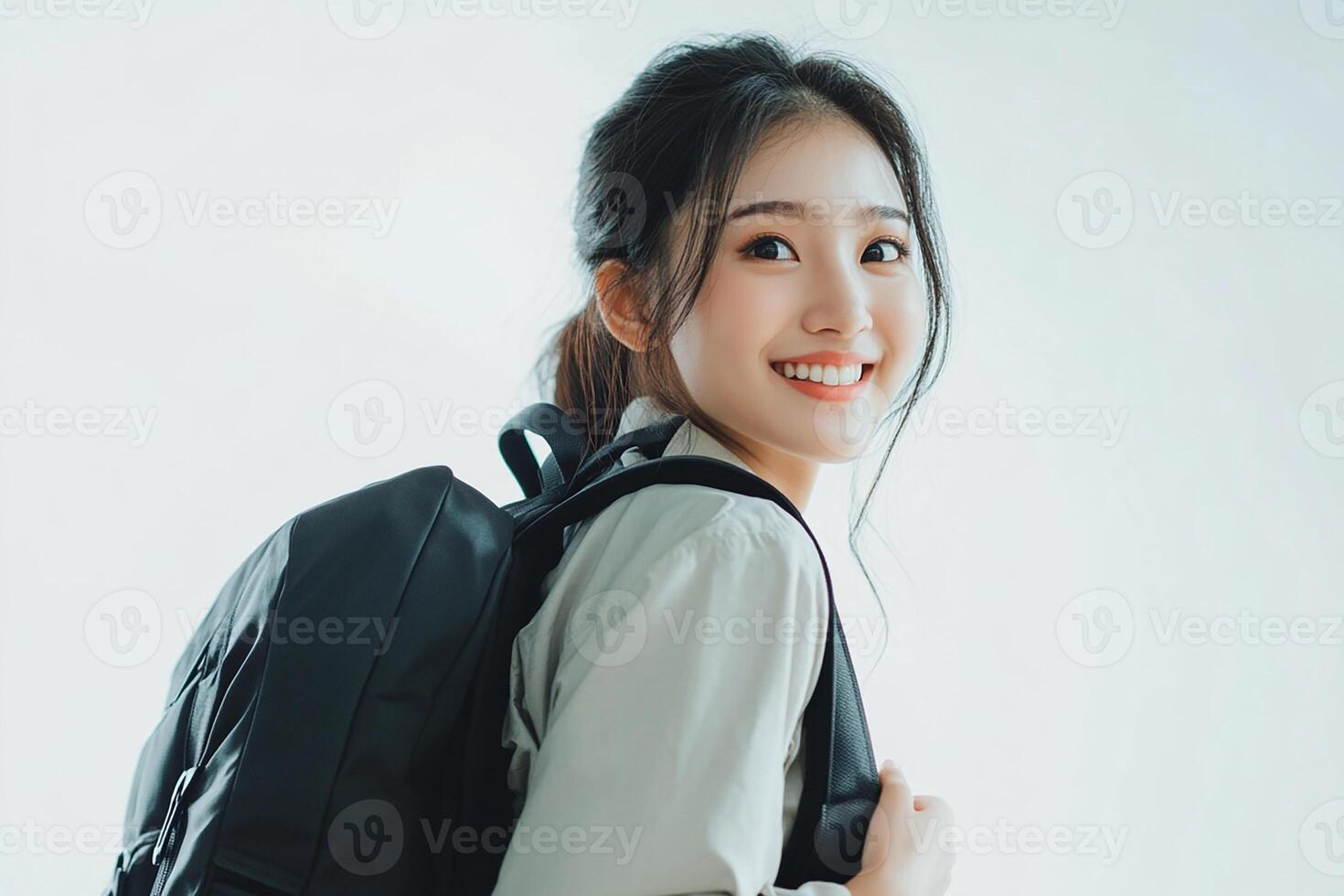 Asian woman with backpack smiling photo
