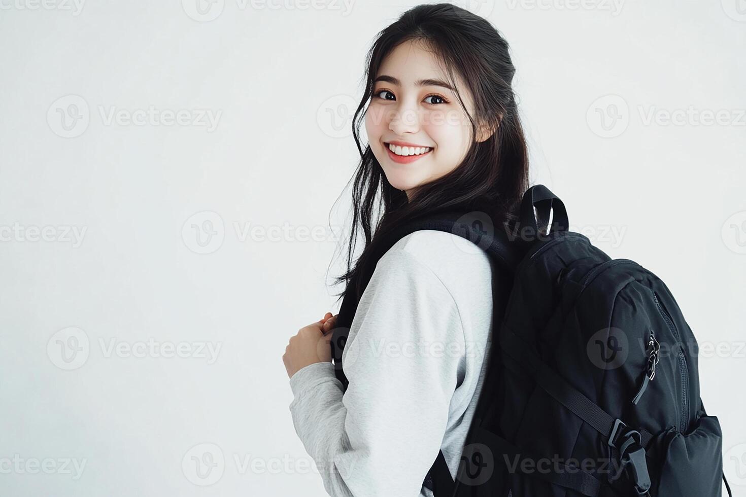 A young woman with a backpack smiling photo