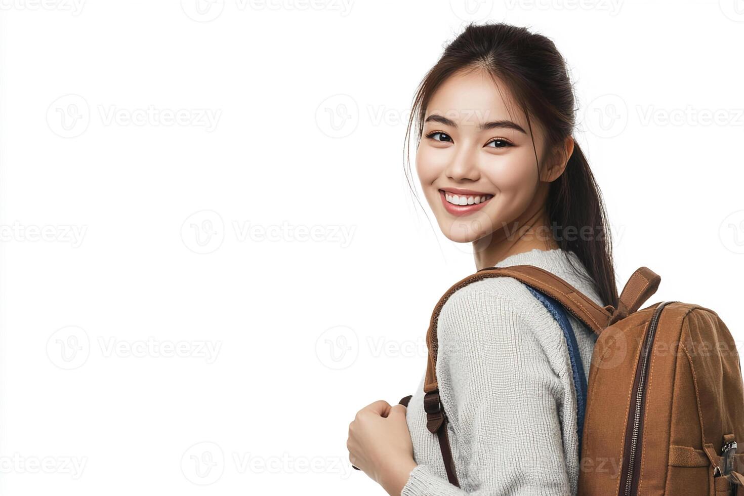 A young woman with a backpack smiling photo