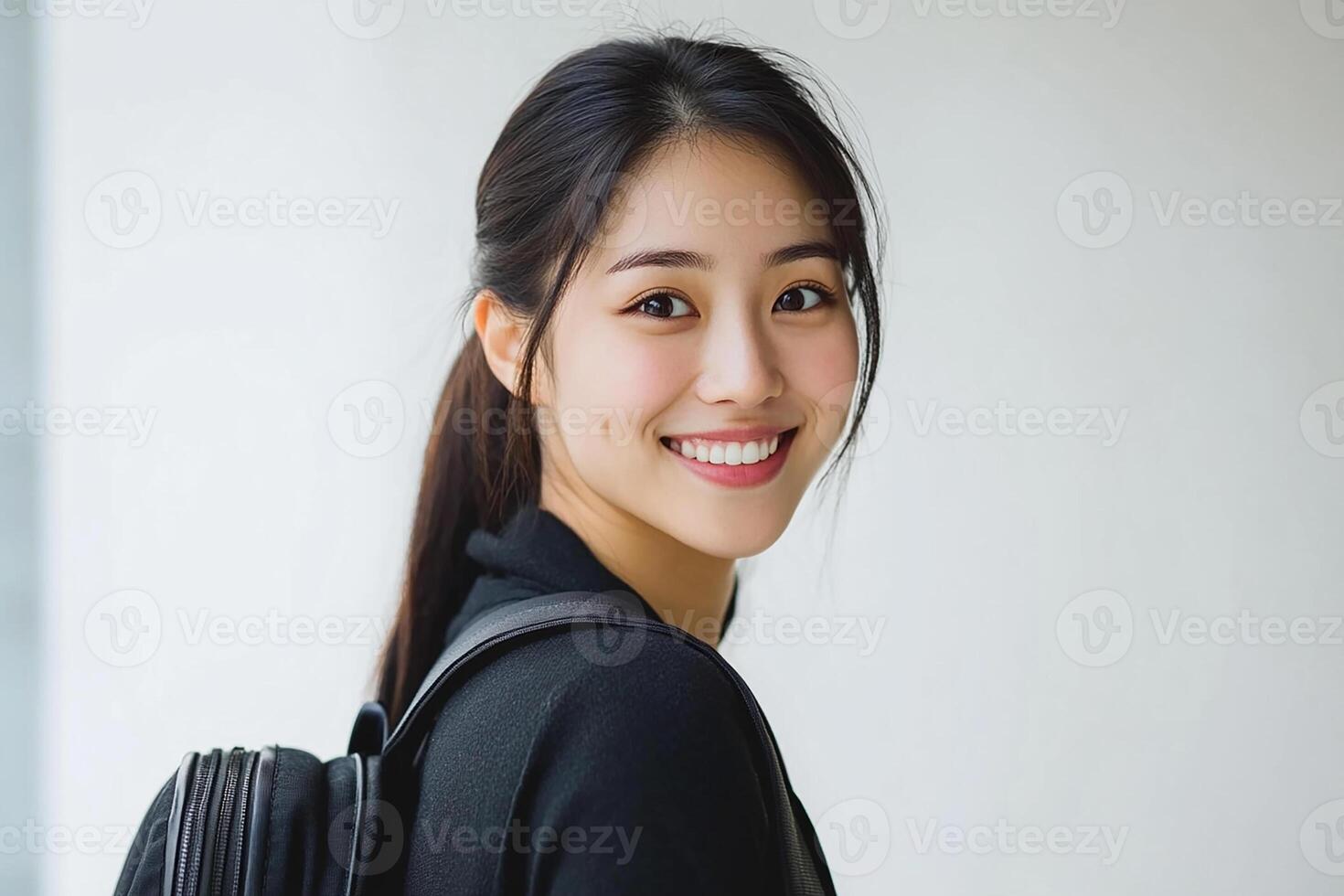 Asian woman with backpack smiling photo
