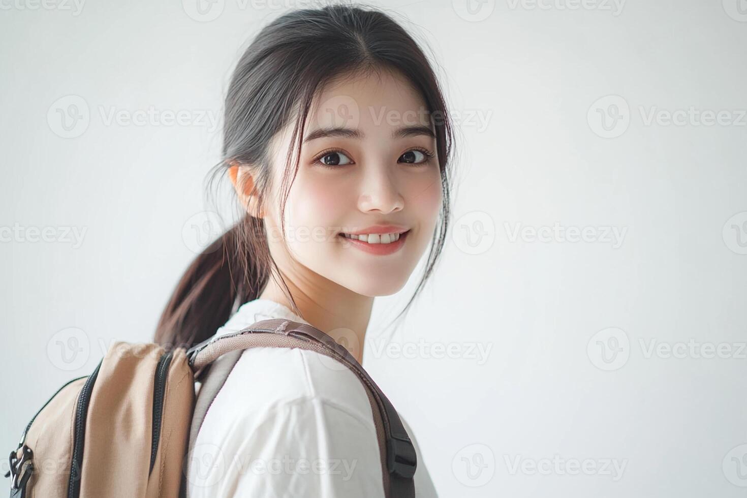 A young woman with a backpack smiling photo