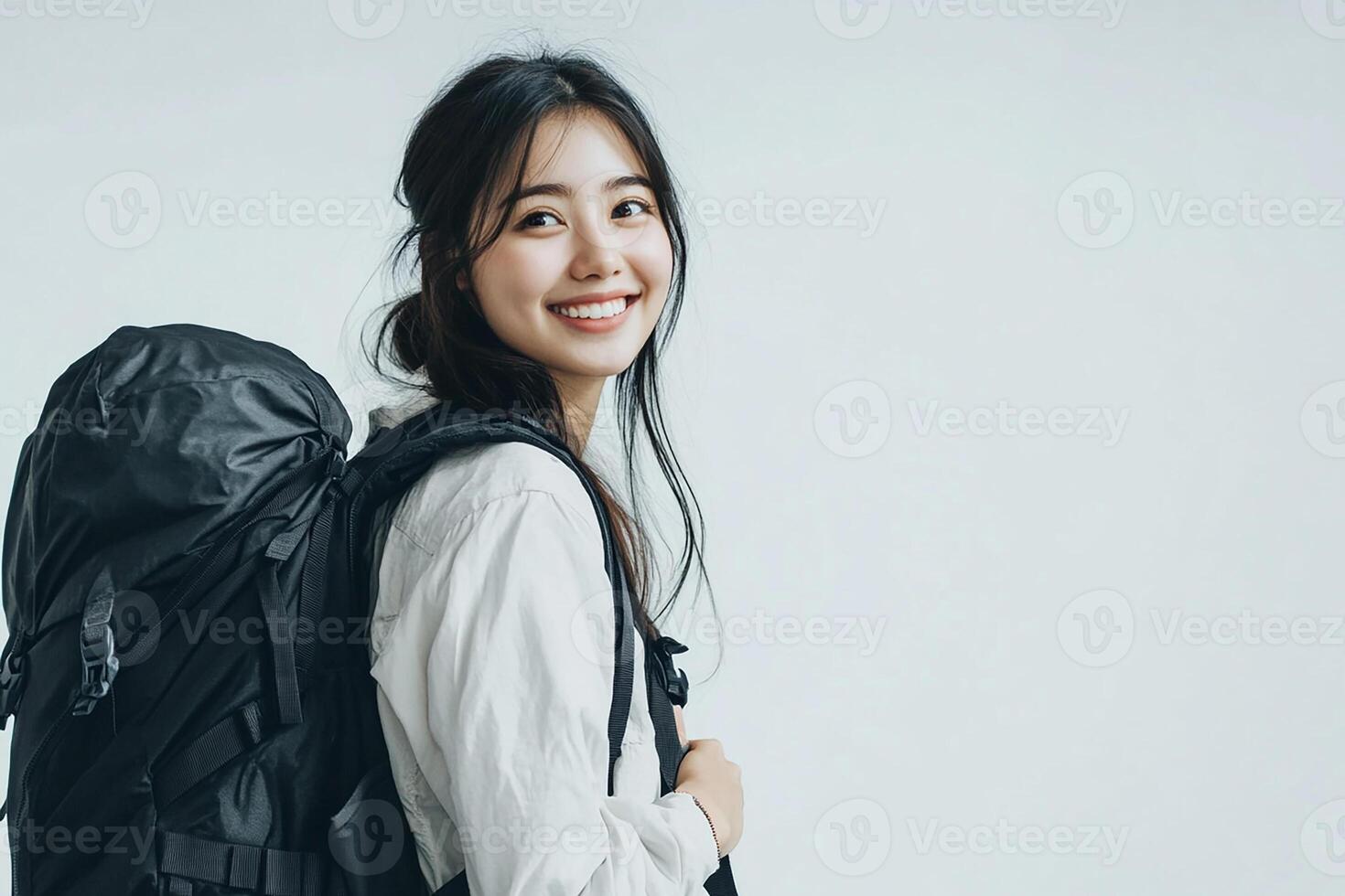 Portrait of asian woman with backpack on white background photo