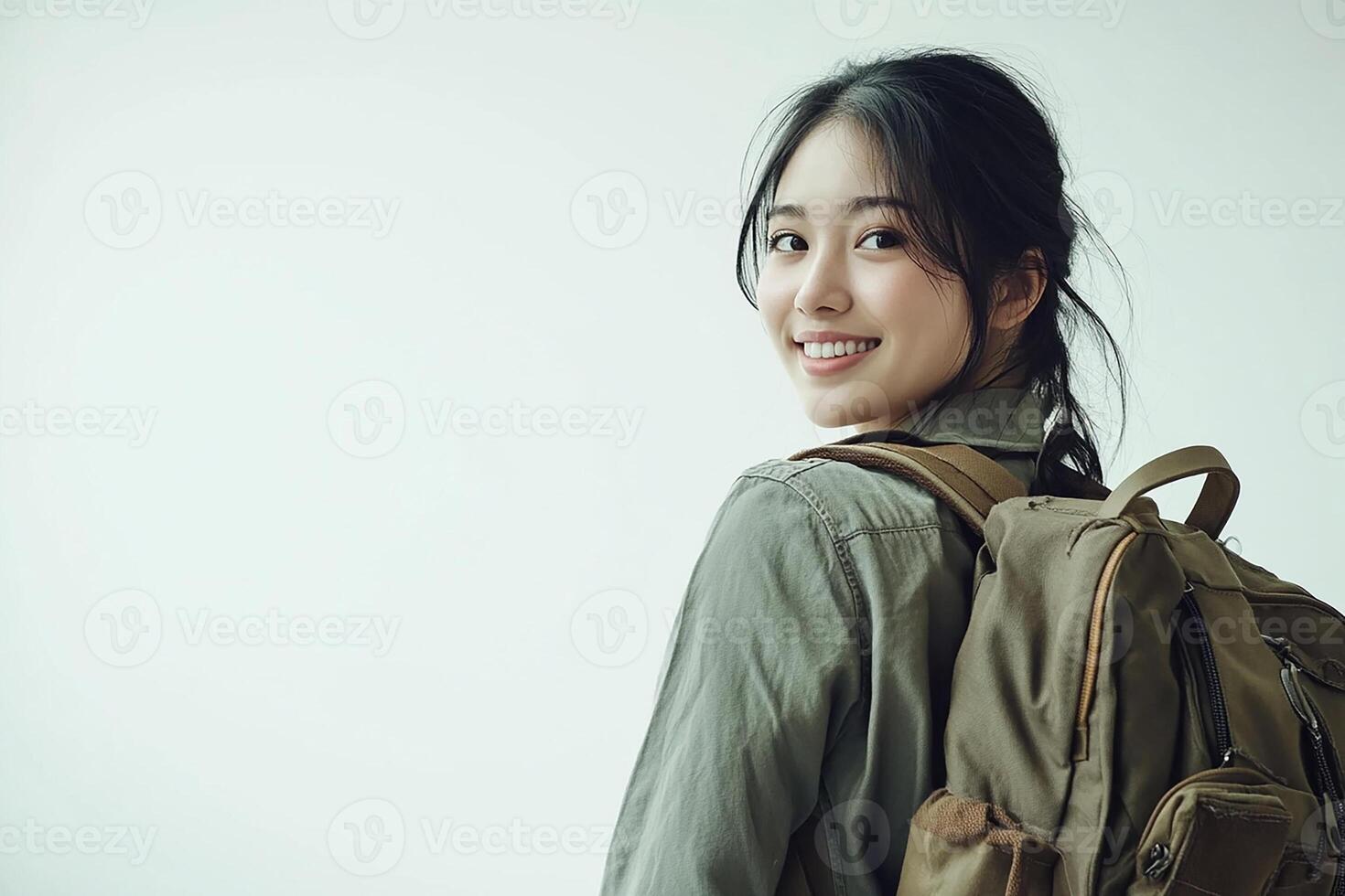 A young woman with a backpack smiling photo