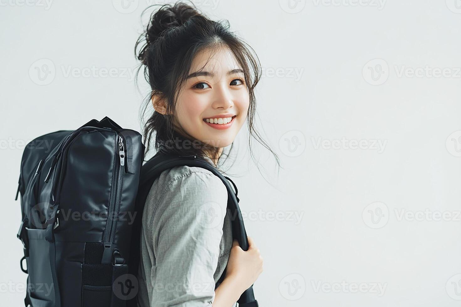 A woman with a backpack smiling photo