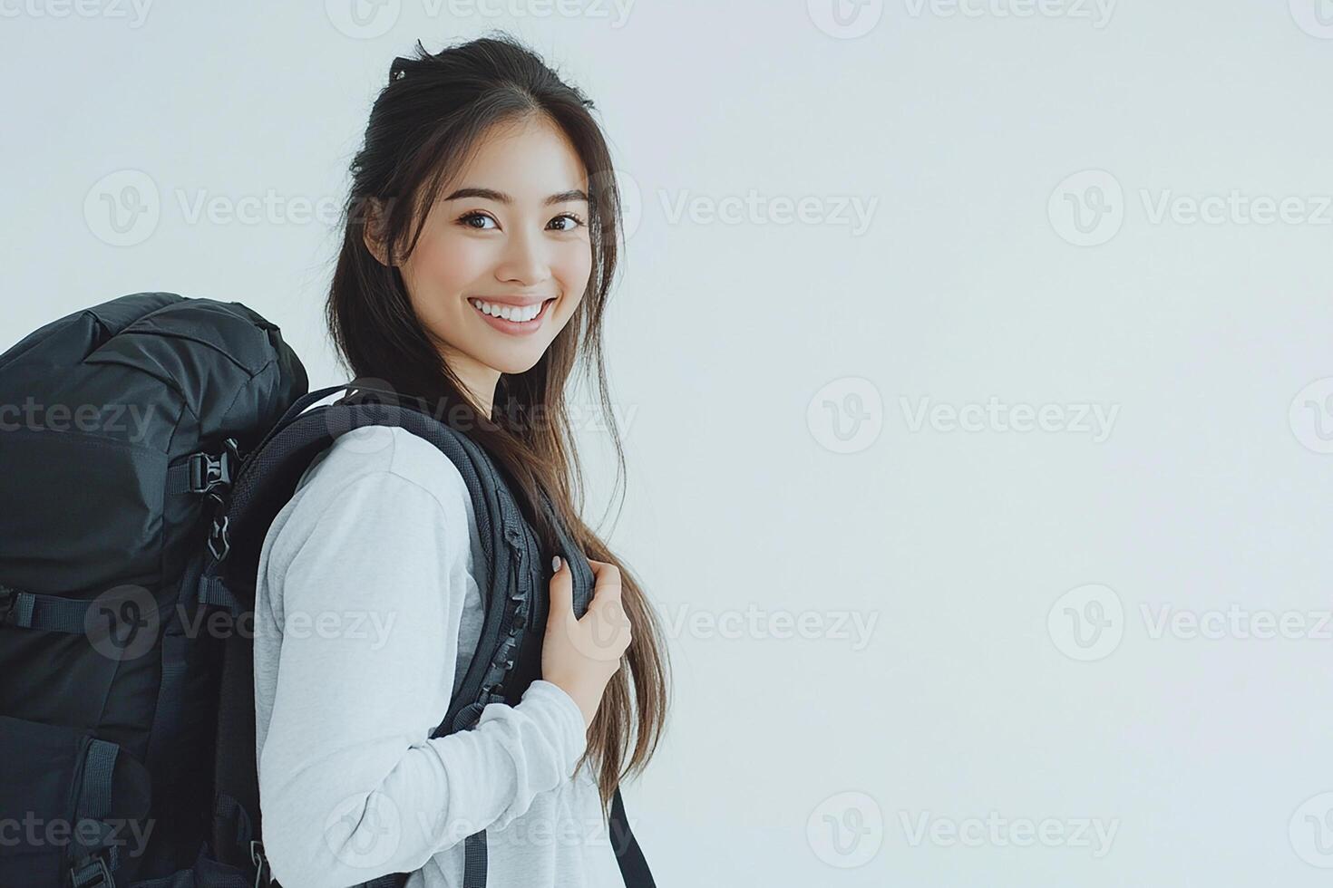 A woman with a backpack smiling photo