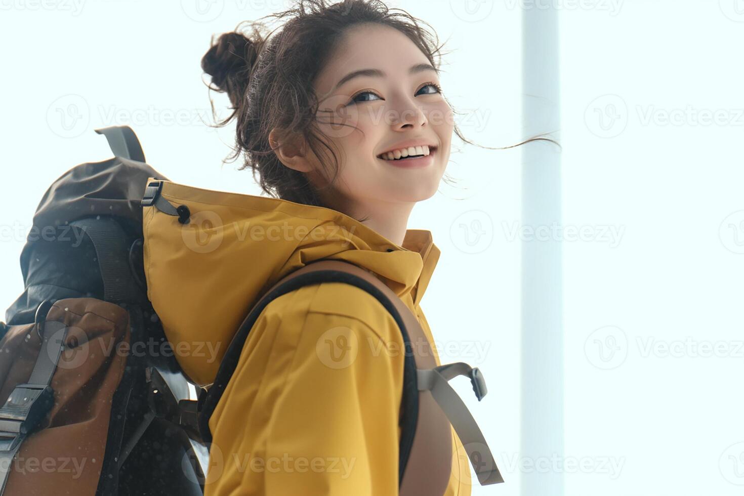 A woman in yellow jacket with backpack photo
