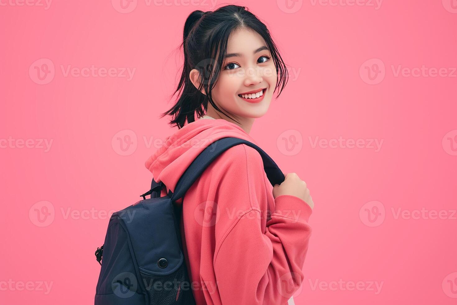 A young woman in a pink jacket and backpack photo