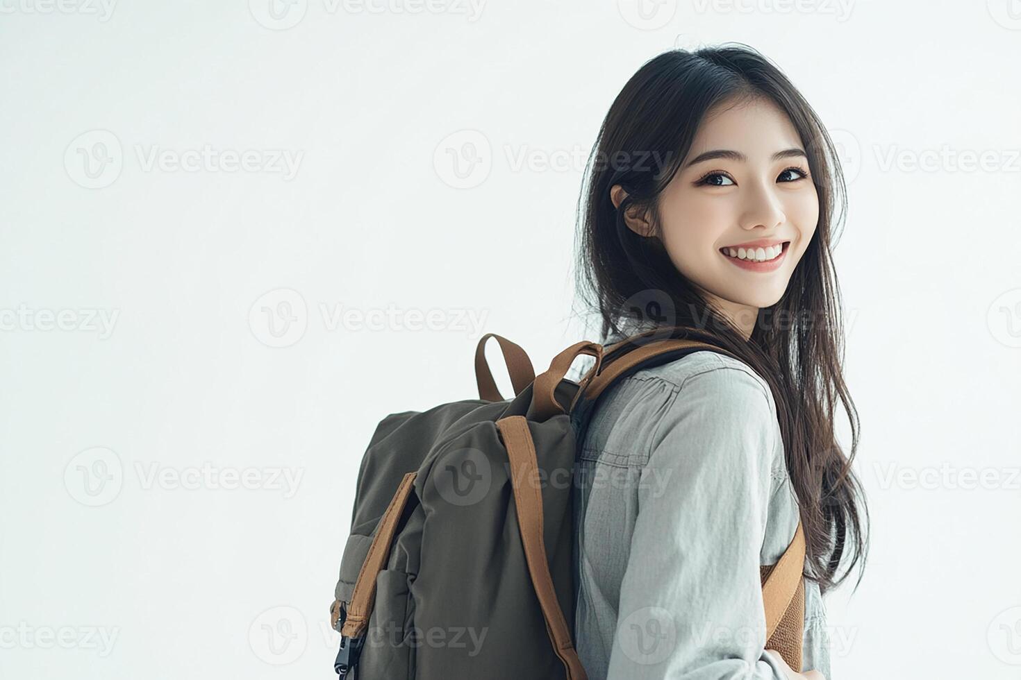 A young woman with a backpack smiling photo