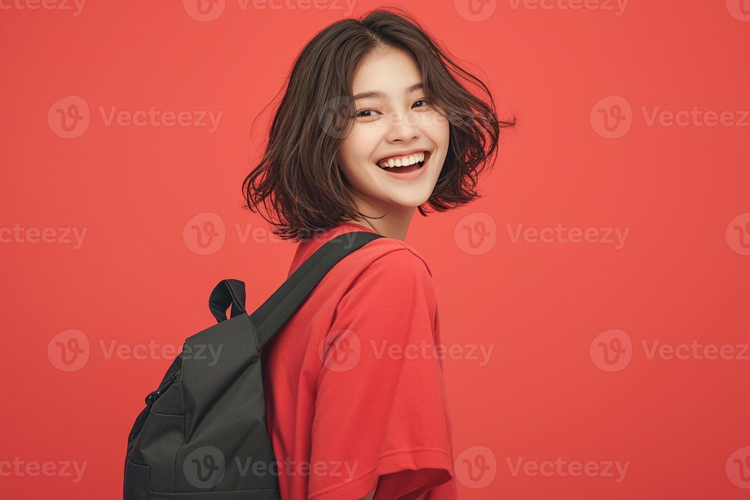 A woman with a backpack smiling and looking at the camera photo