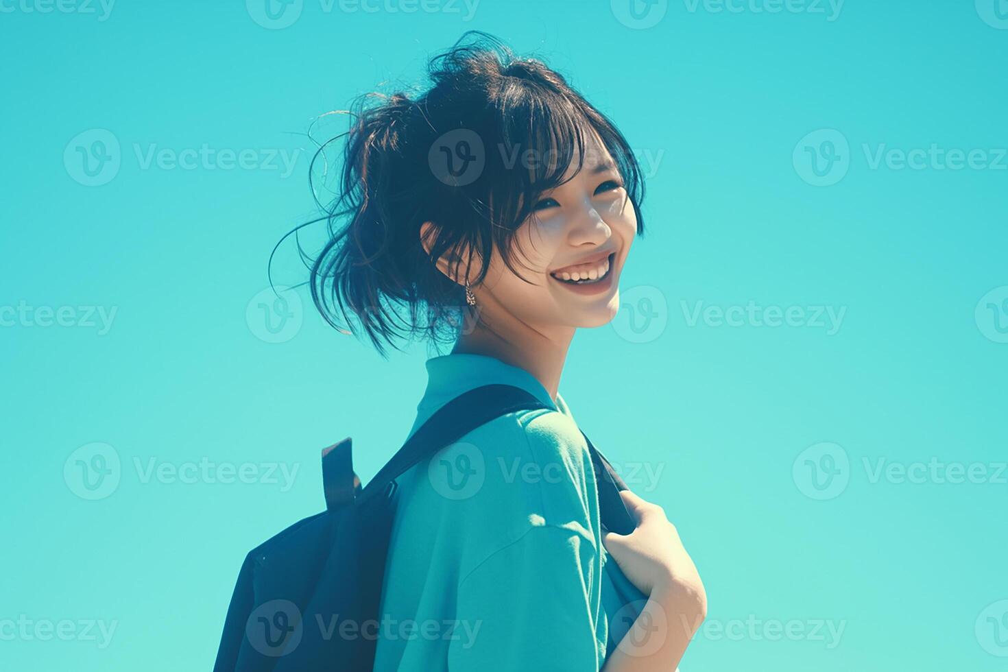 A young woman with a backpack is smiling photo