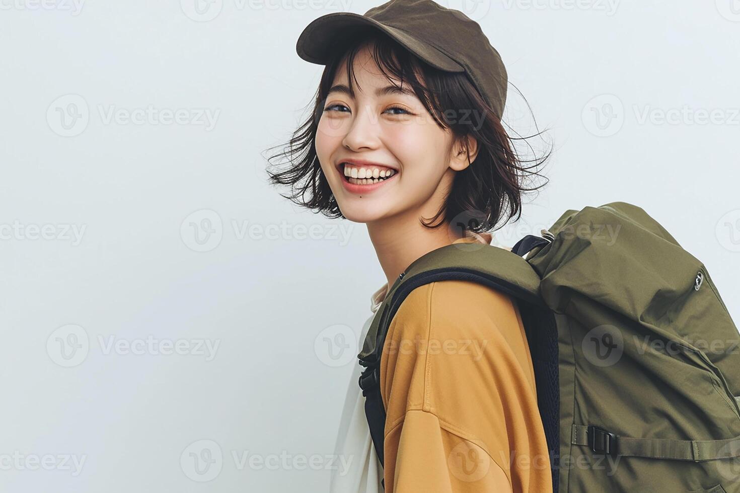 A young woman with a backpack smiling photo