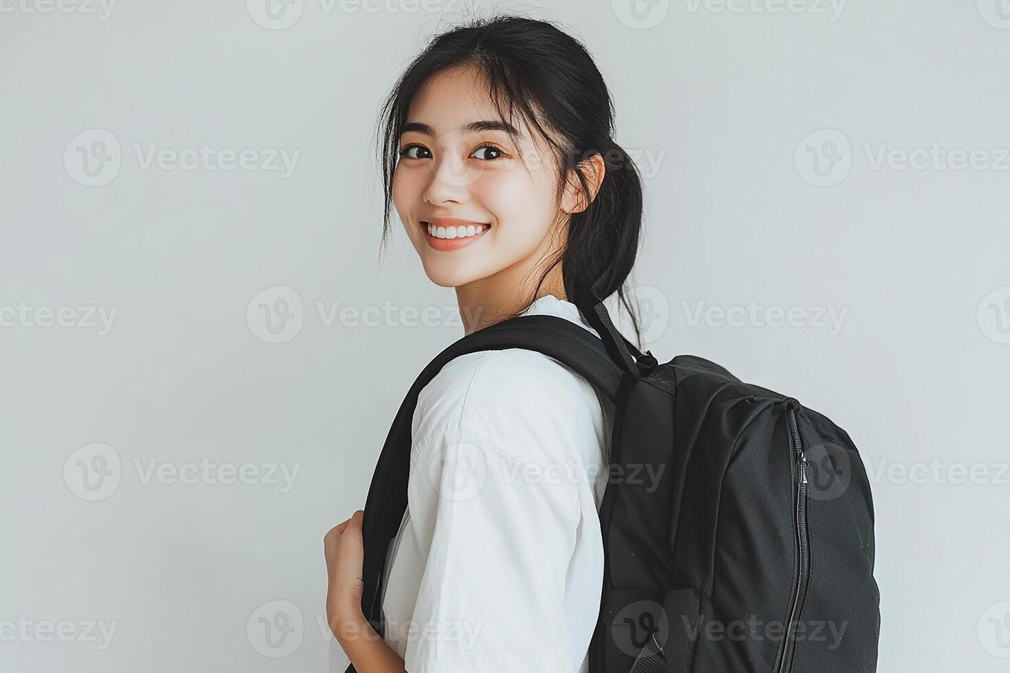 Asian woman with backpack smiling photo