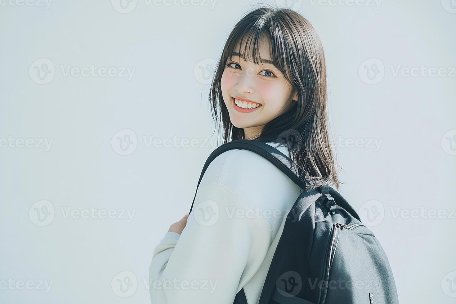 A young woman with a backpack smiling photo