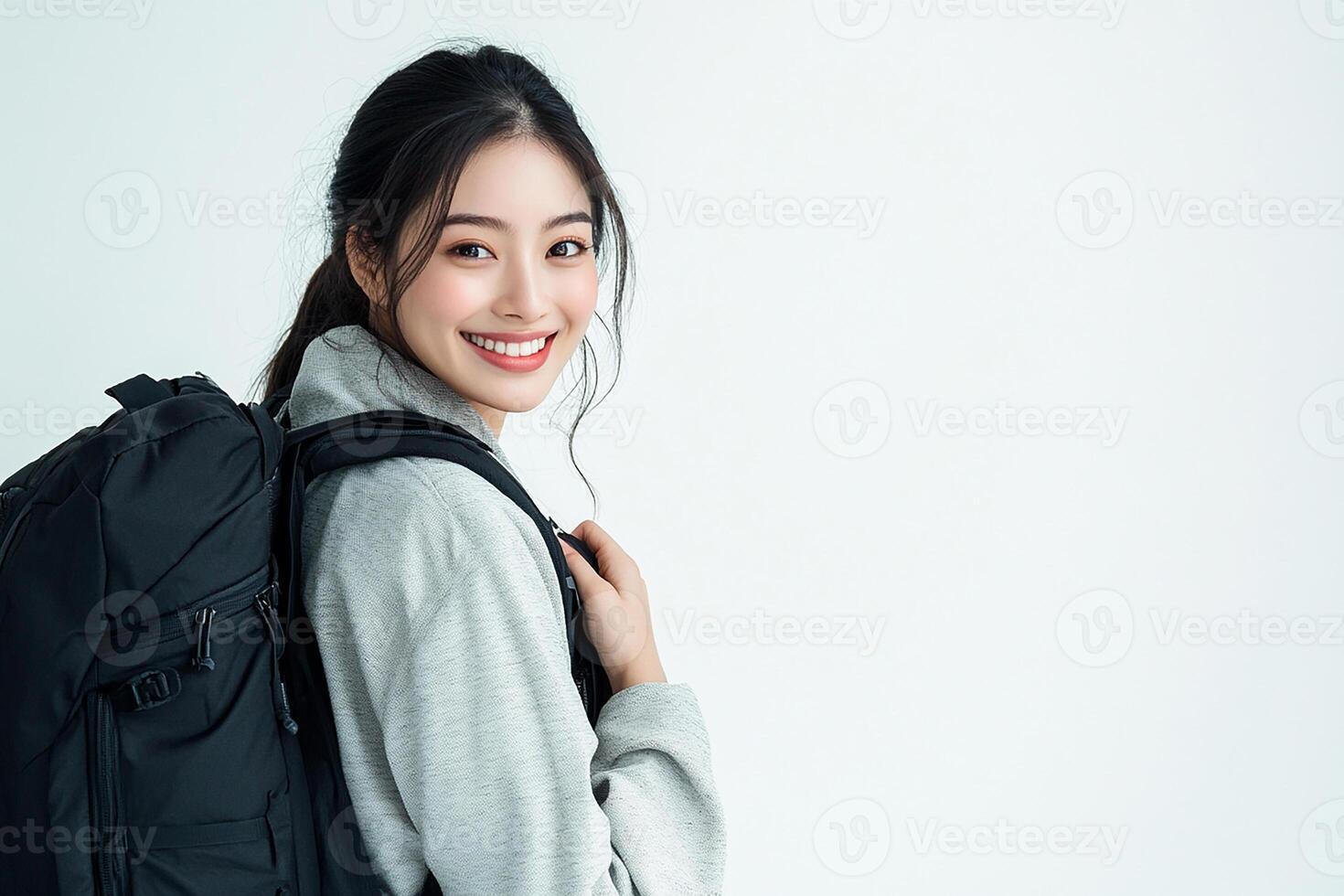 Asian woman with backpack smiling photo