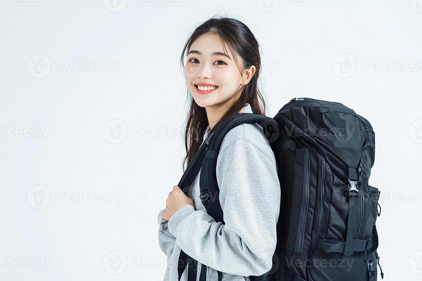 A young woman with a backpack on her back photo
