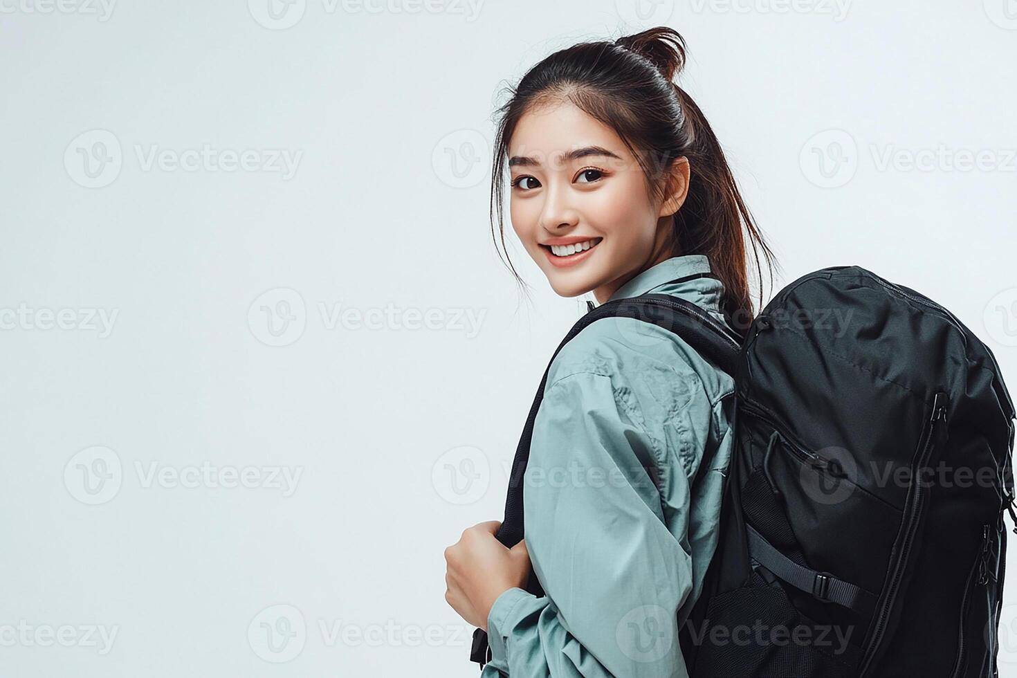 A young woman with a backpack smiling photo