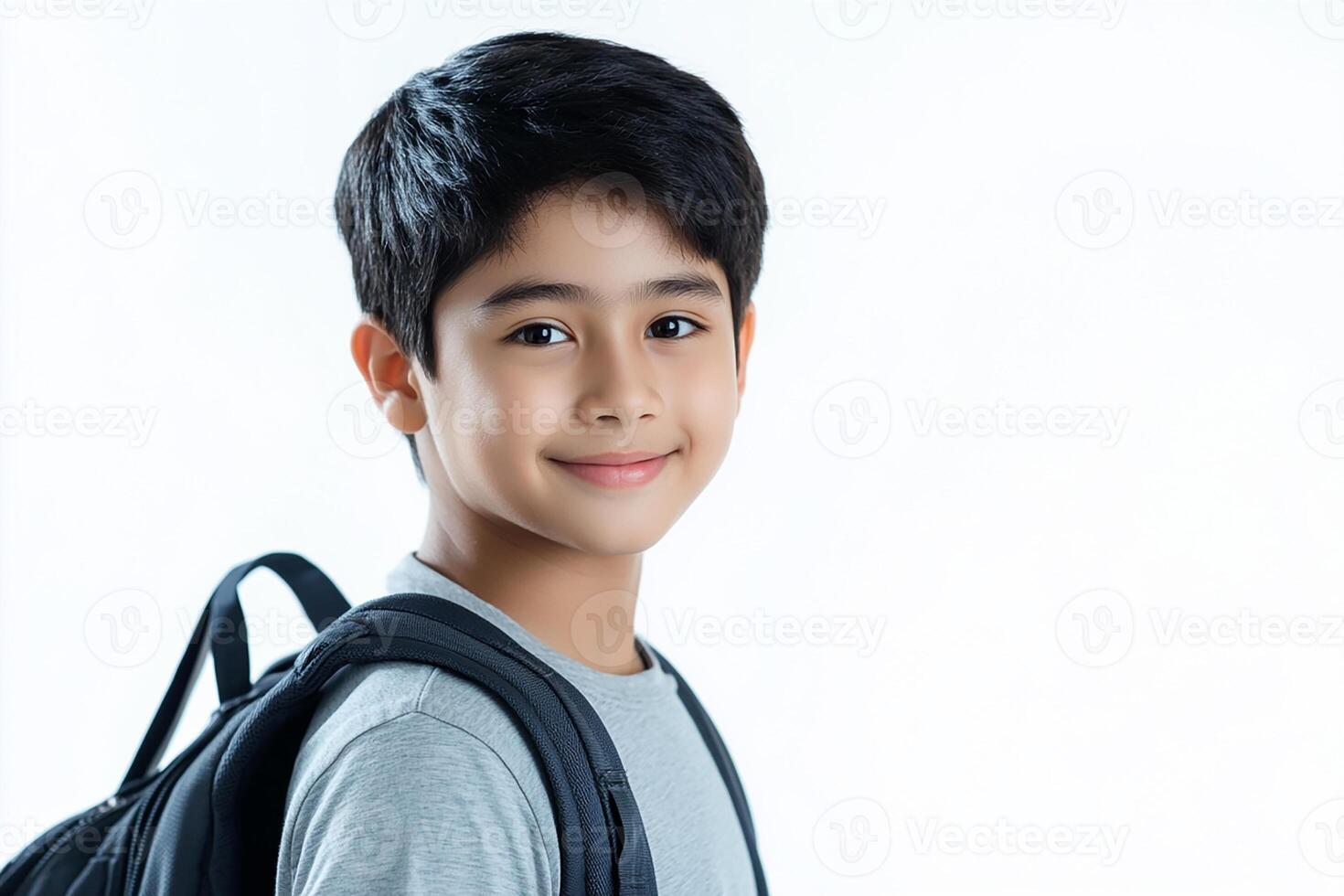 A young boy with a backpack and a smile photo