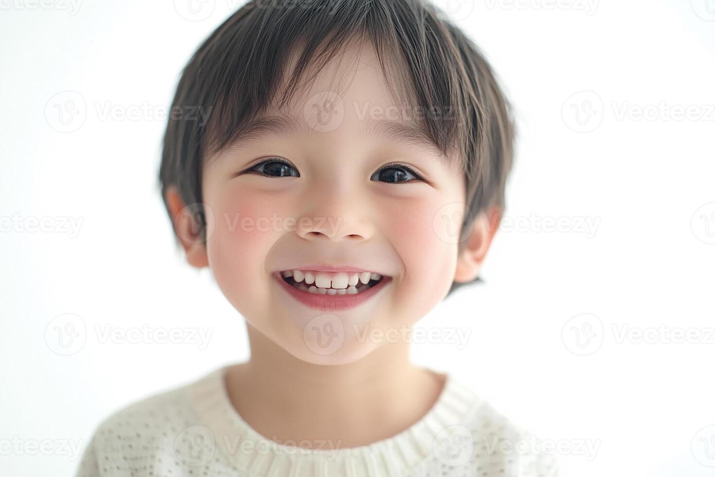 A young boy is smiling and looking at the camera photo