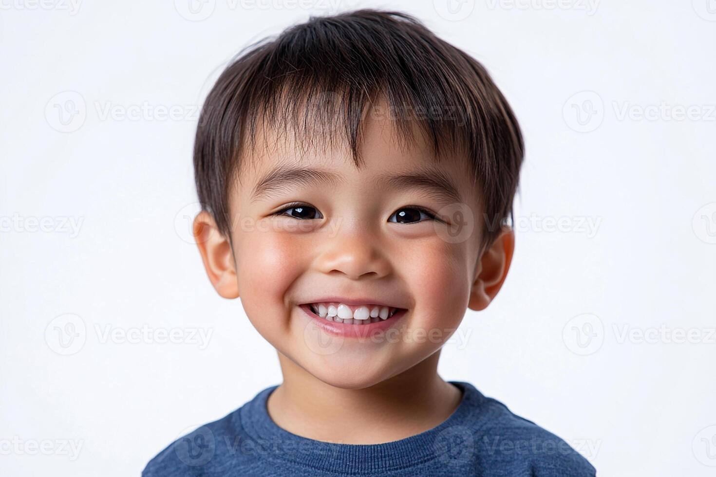A young boy is smiling and posing for the camera photo