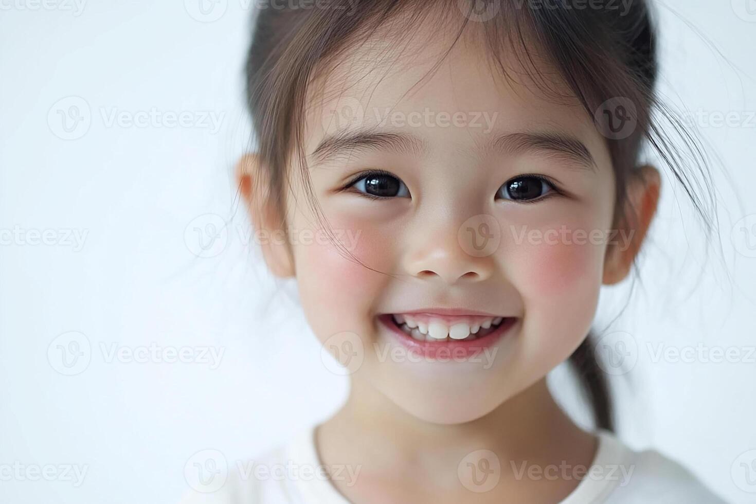 A little girl with long hair smiling photo