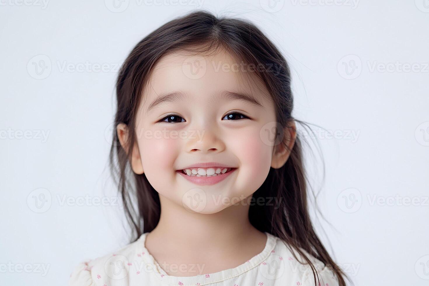 A little girl smiling and posing for the camera photo