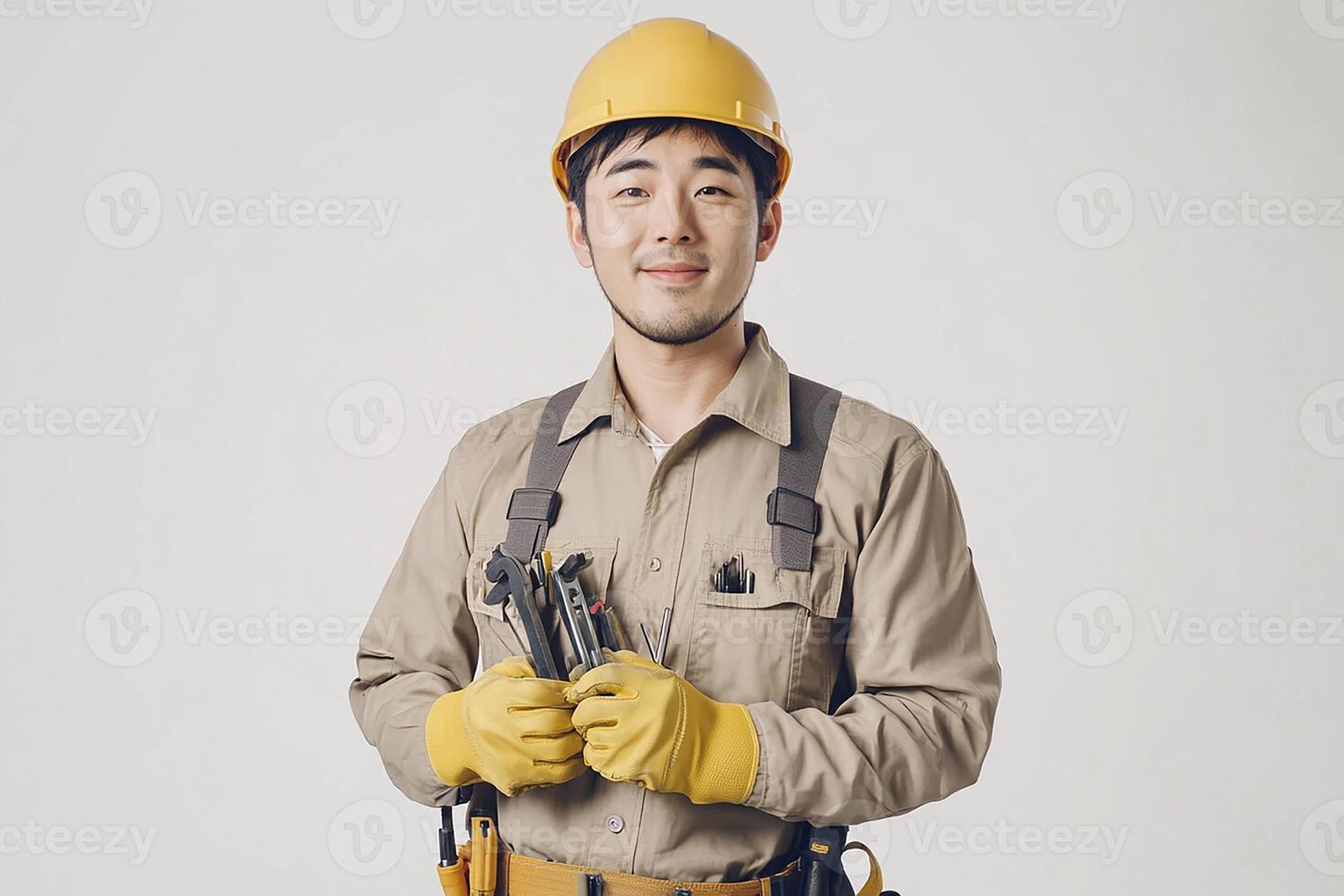 Asian male construction worker holding tools photo