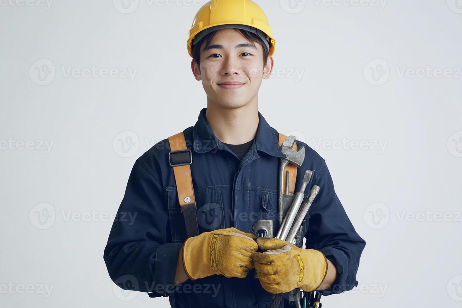 Asian male construction worker holding tools photo