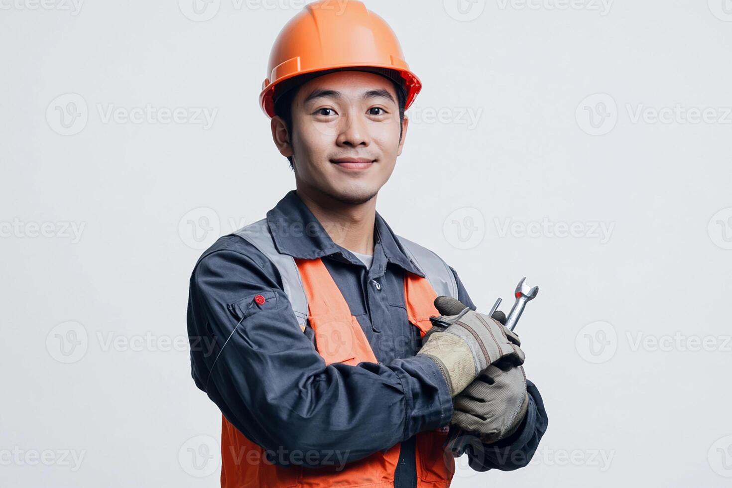 Asian man in hard hat holding a wrench photo