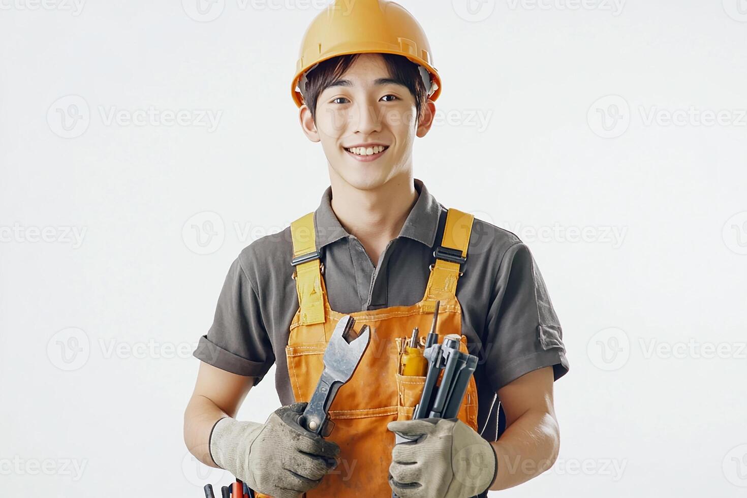 Asian male construction worker holding tools photo