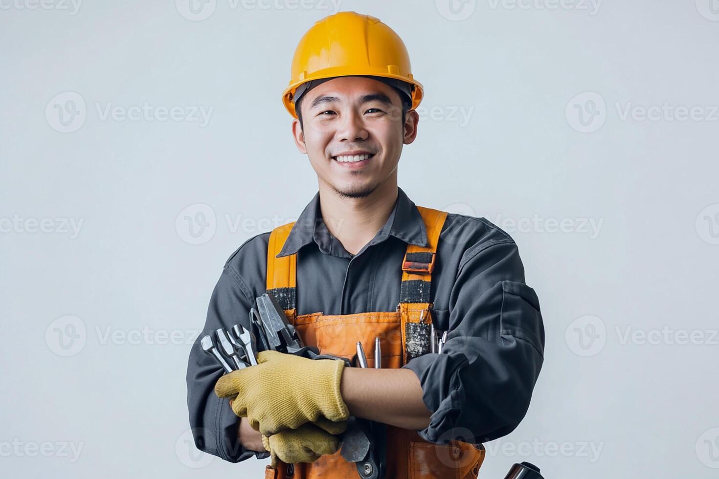 Asian male construction worker holding tools photo