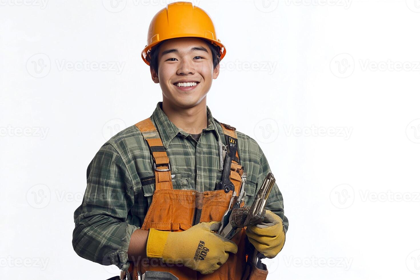 A smiling young man in overalls holding a wrench photo