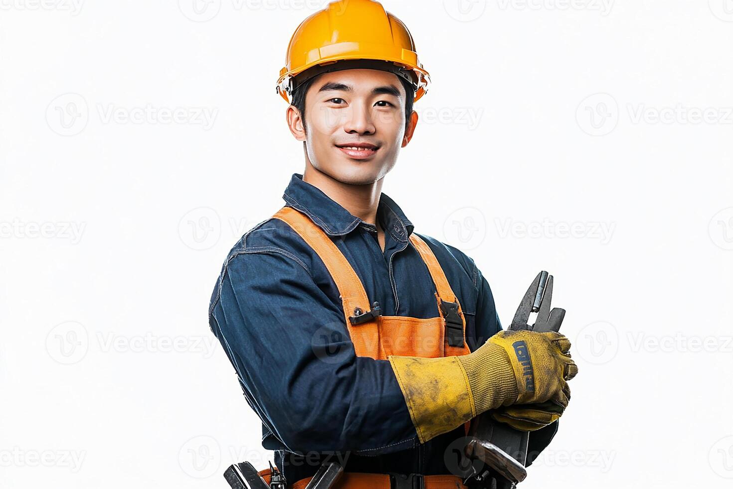 A man in an orange hard hat and overalls holding a wrench photo