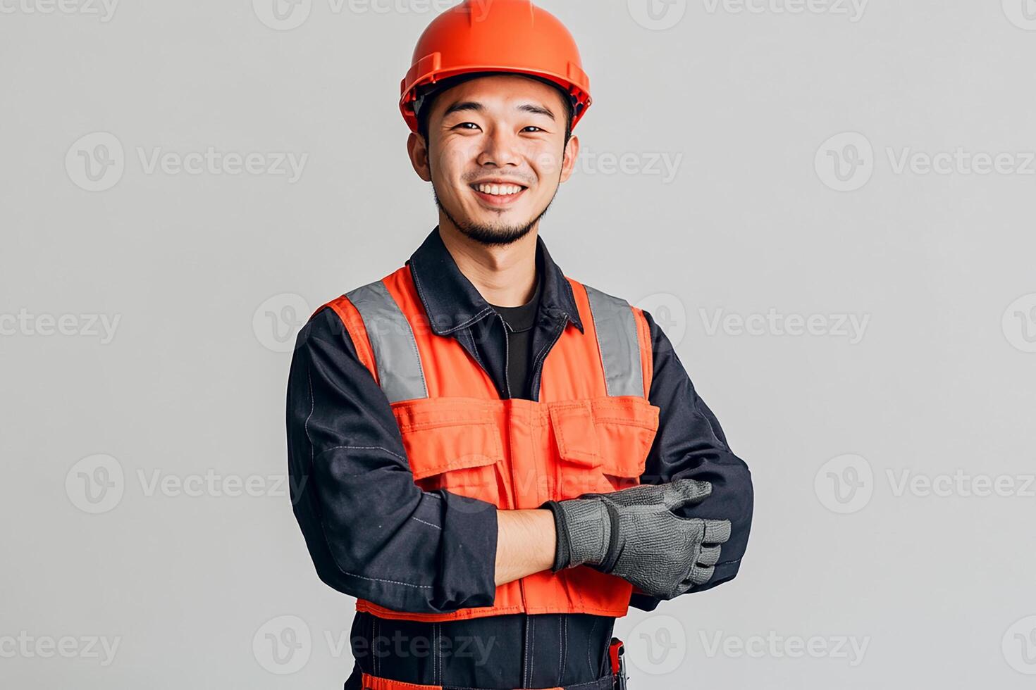 Asian man in orange vest and hard hat photo