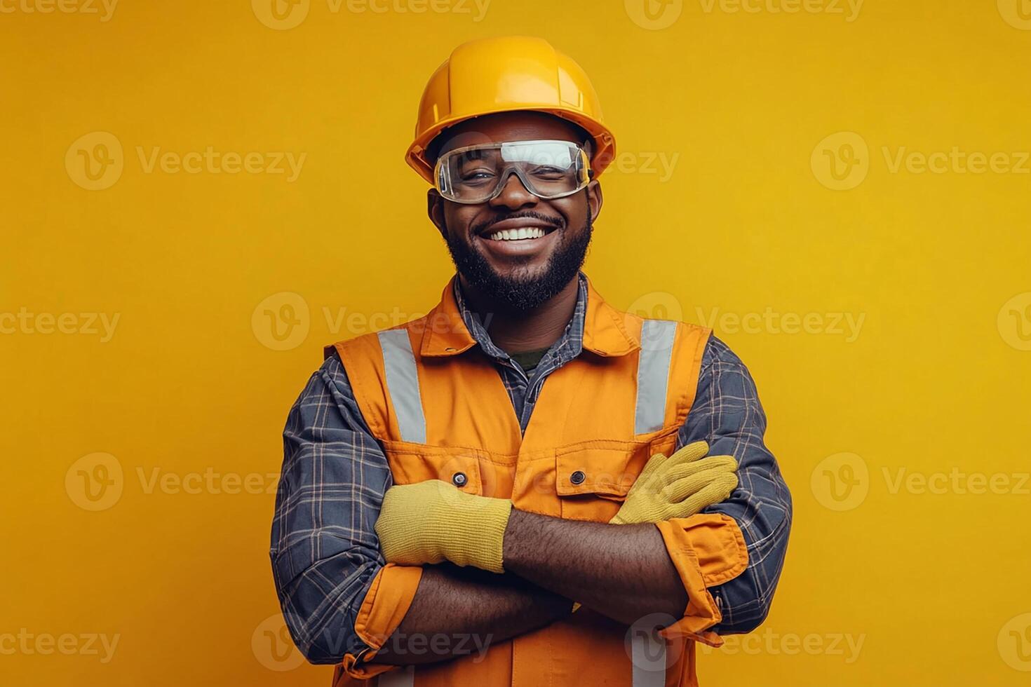 Portrait of a smiling african american man in safety vest and helmet on yellow background photo