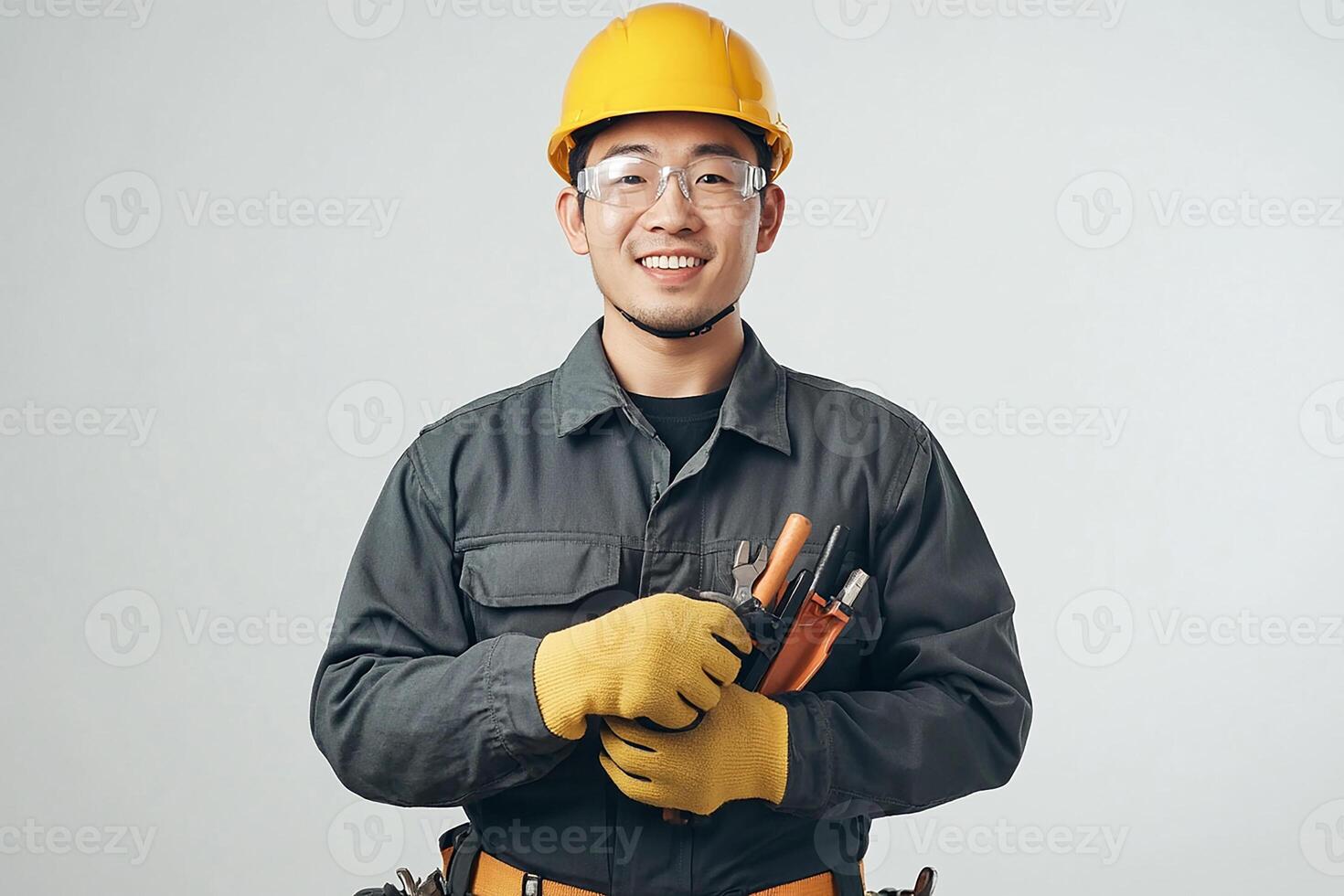 A man in a hard hat and gloves holding a wrench photo