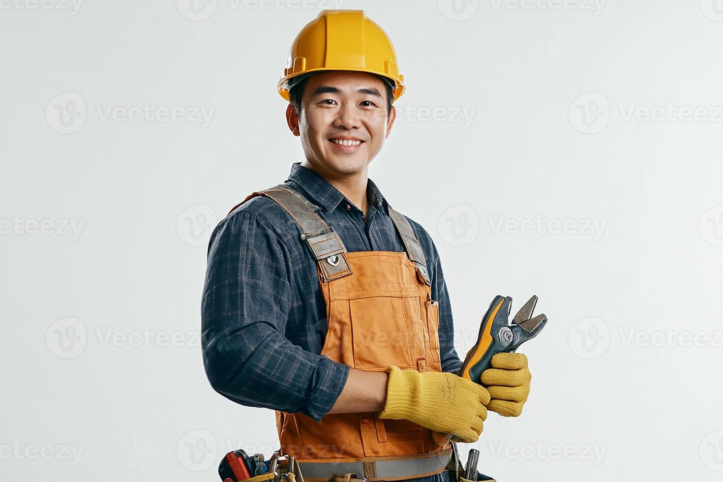 Asian male construction worker holding tools photo