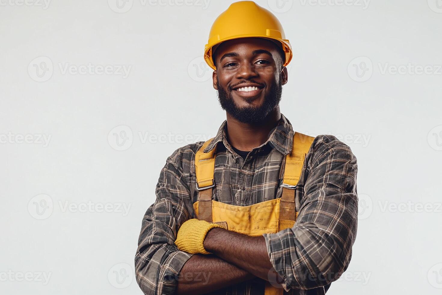 A smiling black man in a hard hat and overalls photo