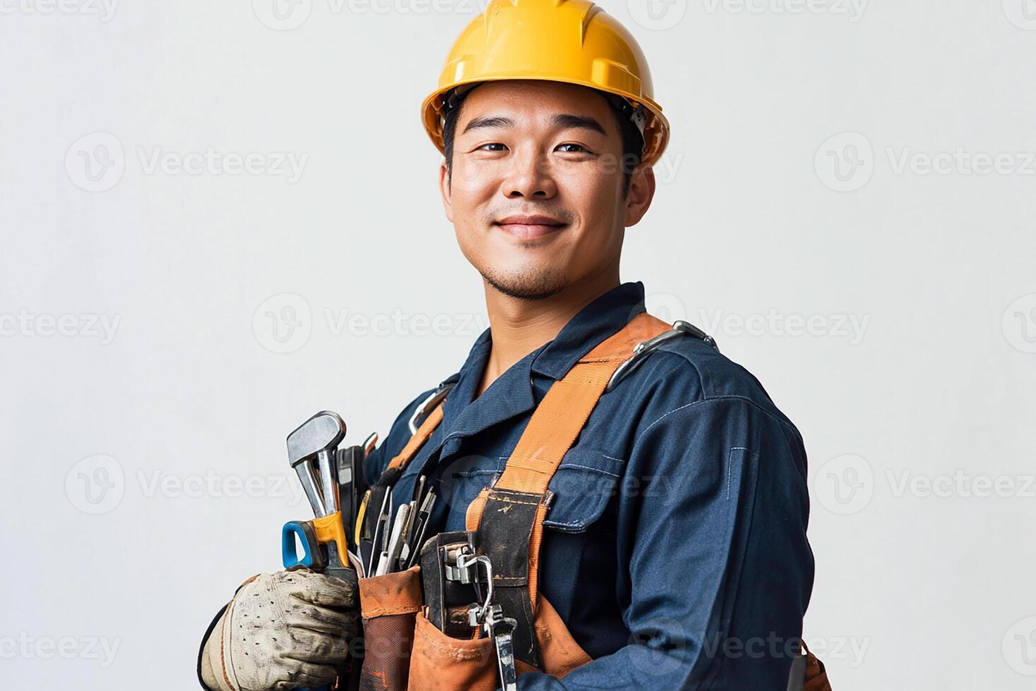 Asian male construction worker holding tools photo