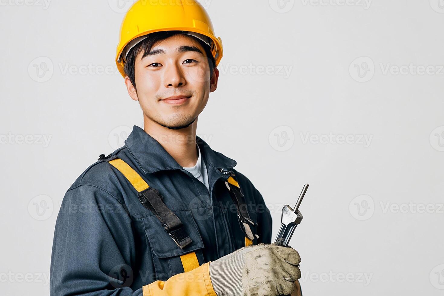 Asian male construction worker holding a wrench photo
