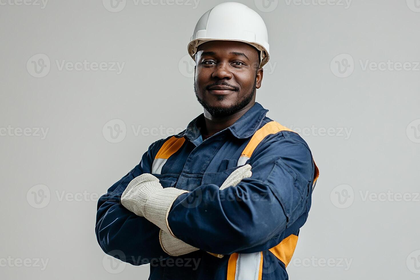An african american man in a hard hat and overalls photo