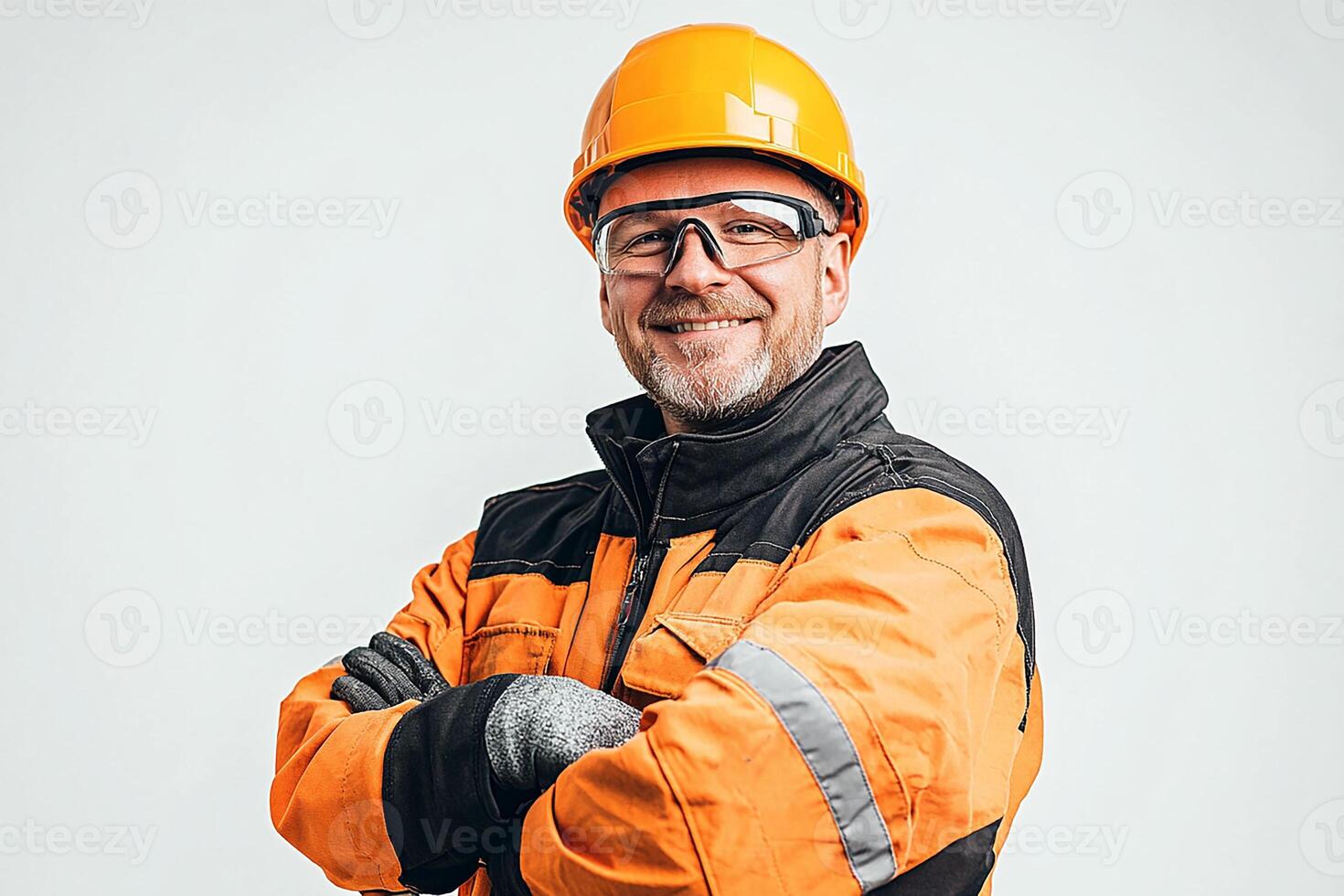 A man in an orange and black jacket and helmet photo