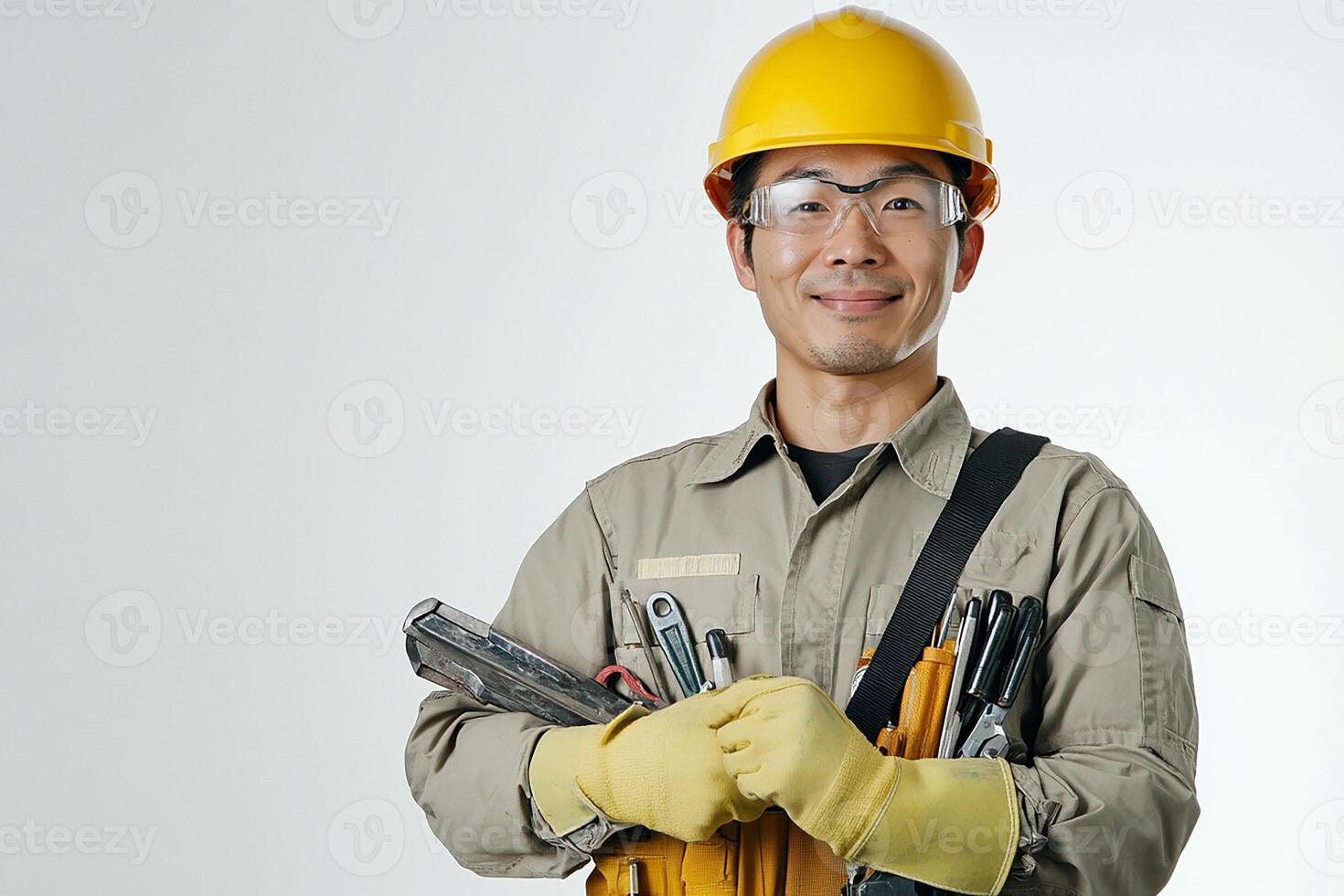 Asian male construction worker holding tools photo