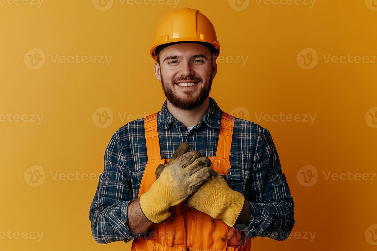 A smiling man in an orange overalls and gloves photo