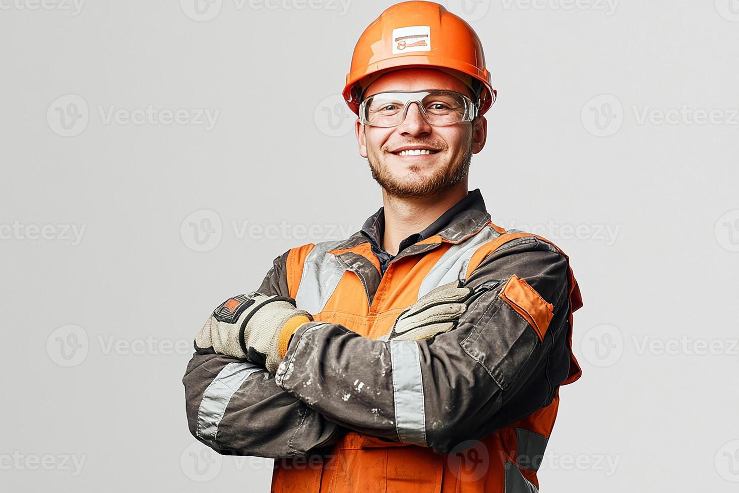 A man in an orange and white hard hat and safety glasses photo