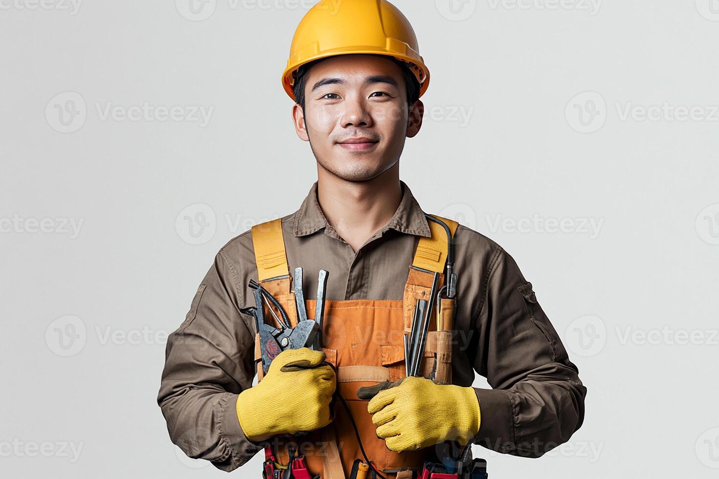 Asian male construction worker holding tools photo